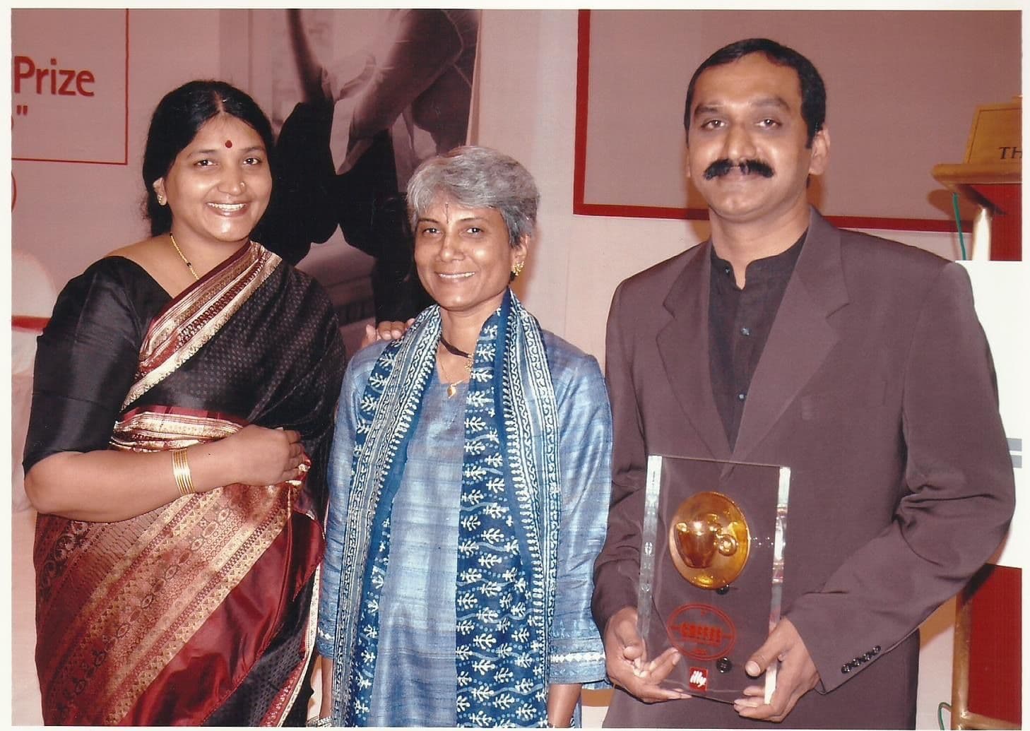 Members posing with an award