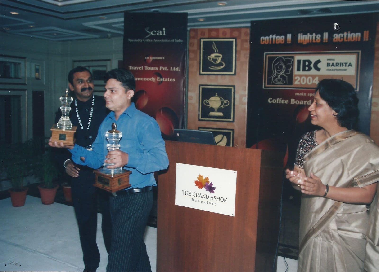 Champion holding a trophy on stage
